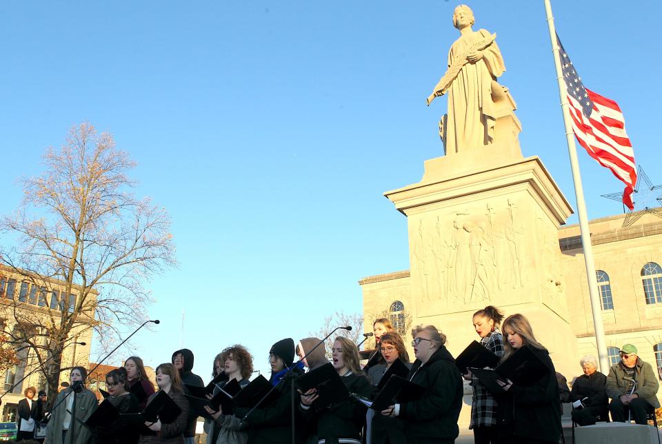 BNL and Mitchell Choirs combine to sing "America the Beautiful" during the 100th Anniversary of the placement of the  Miss Indiana Statue atop the Lawrence County Soldiers, Sailors, and Pioneers MonumentMonday, Nov. 27, 2023.