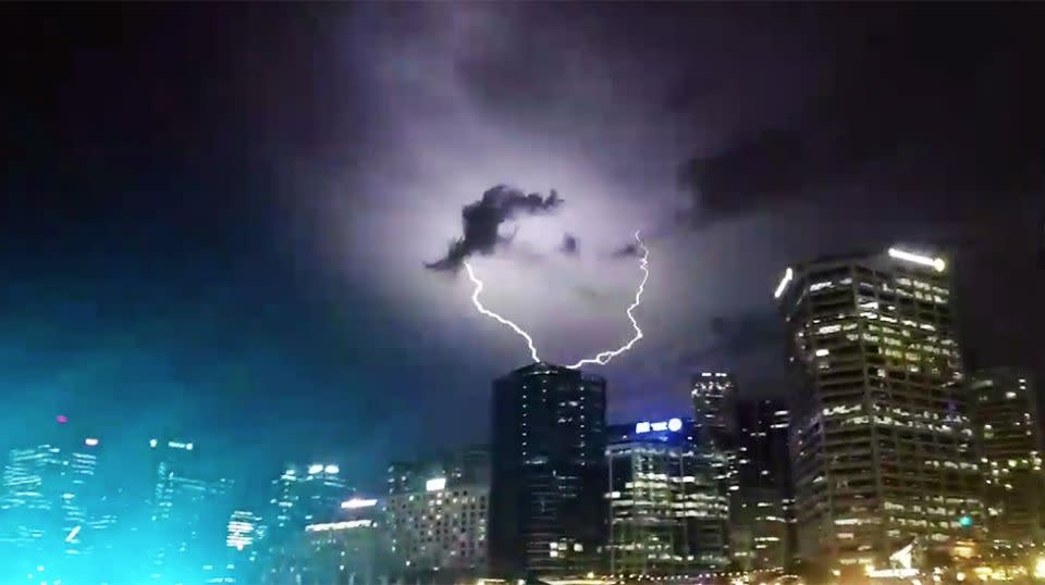 An incredible crack of purple and white lightning zapped a building in Sydney’s CBD. Photo: Twitter/DaveTheHappySinger