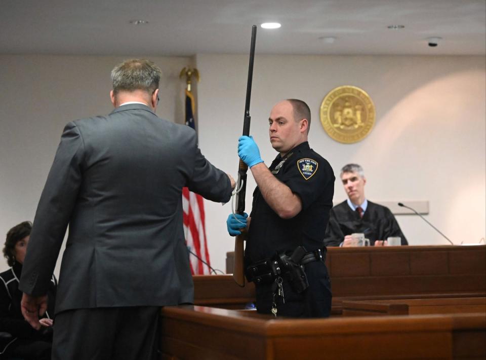 Washington County First Assistant District Attorney Christian P. Morris directs a NYS Court Police officer to hold Kevin Monahan's shotgun during his murder trial (AP)