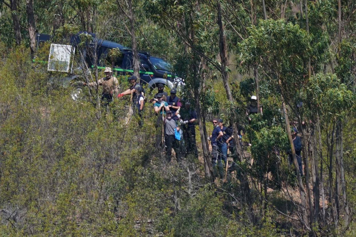 Personnel at Barragem do Arade reservoir, in the Algave, Portugal, as searches continue as part of the investigation into the disappearance of Madeleine McCann (PA)