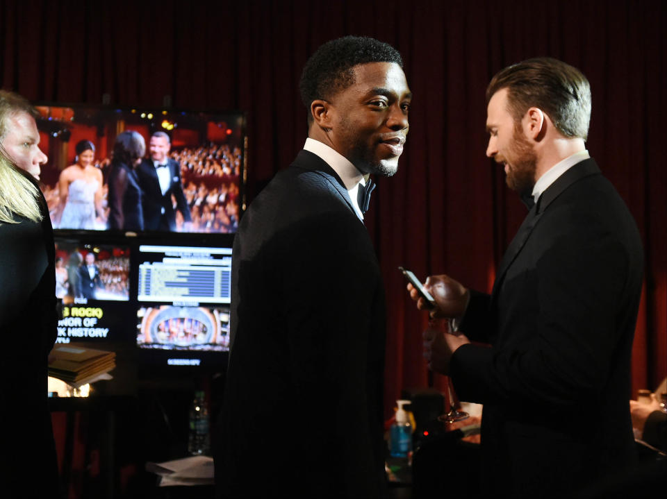 Feb 28, 2016; Hollywood, CA, USA; Chadwick Boseman and Chris Evans wait backstage during the 88th annual Academy Awards at the Dolby Theatre. Mandatory Credit: Robert Hanashiro-USA TODAY NETWORK 