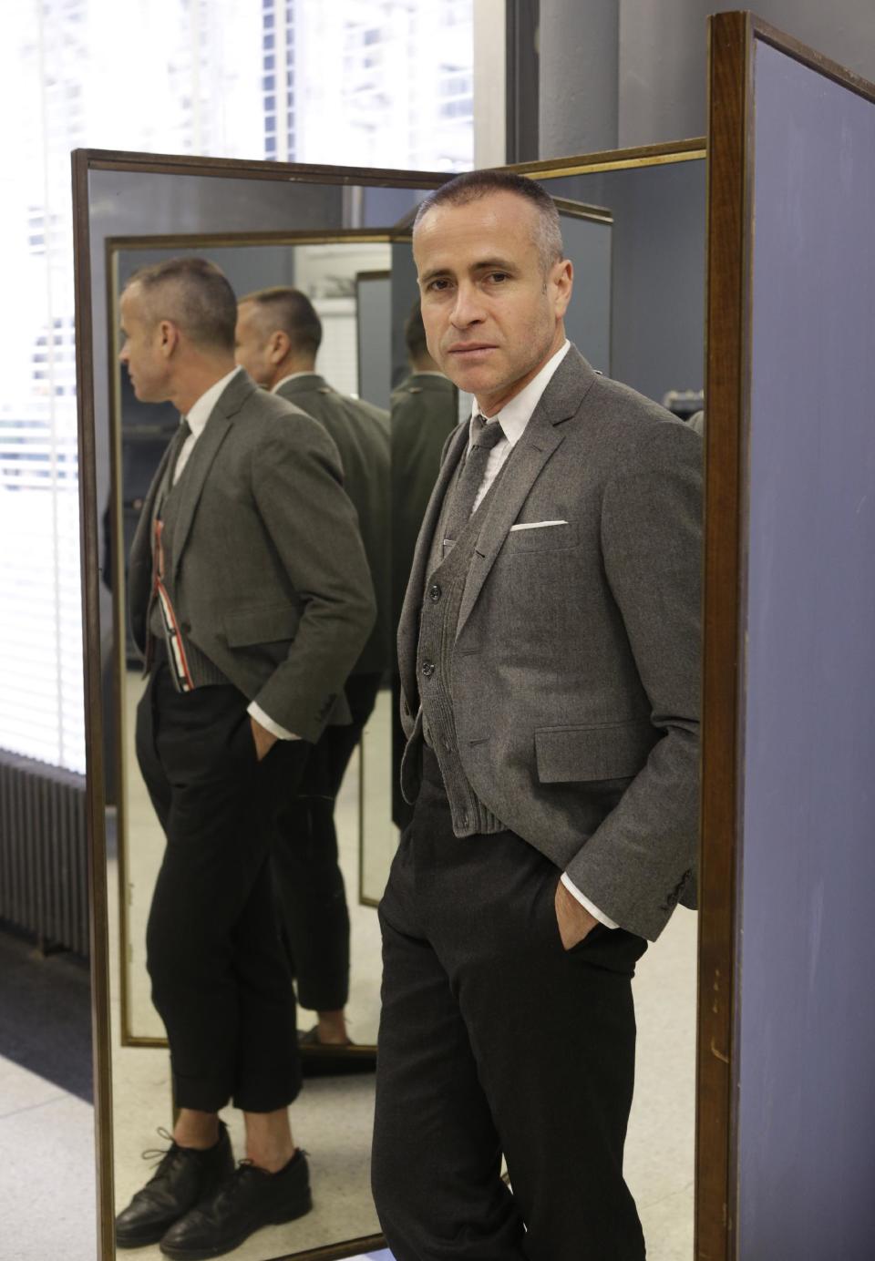 Fashion designer Thom Browne poses for a photograph at his Hudson Street store in New York, Wednesday, Feb. 20, 2013. Browne is building a business _ and what he hopes is a smart, long-lasting business at that. He's just not the overzealous, mercurial artiste. (AP Photo/Kathy Willens)