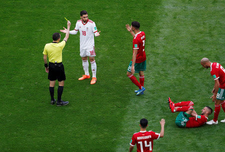 Soccer Football - World Cup - Group B - Morocco vs Iran - Saint Petersburg Stadium, Saint Petersburg, Russia - June 15, 2018 Iran's Alireza Jahanbakhsh is shown a yellow card by referee Cuneyt Cakir REUTERS/Lee Smith