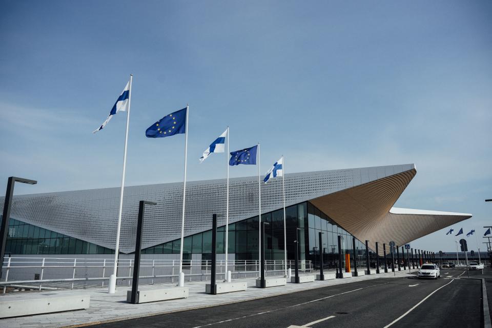 Finnish and EU flags wave outside of the Terminal 2 of the Helsinki airport is pictured on August 19, 2022, in Vantaa, Finland. - Luxury sports cars are filling up the parking garage at Helsinki's airport, as Finland becomes an important transit country for Russian tourists flying into Europe. (Photo by Alessandro RAMPAZZO / AFP) (Photo by ALESSANDRO RAMPAZZO/AFP via Getty Images)