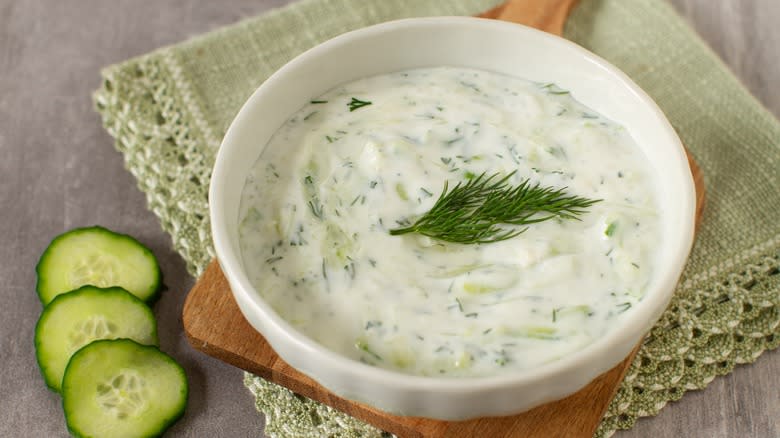 Tzatziki in bowl with cucumber