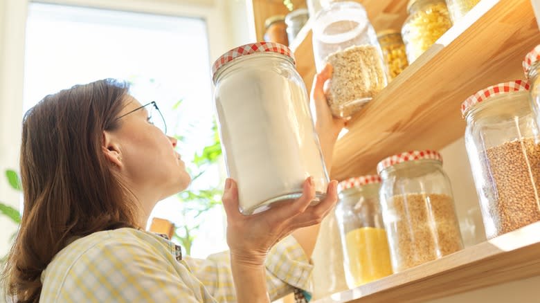 Woman taking ingredients from pantry