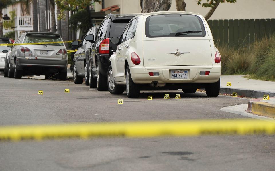 Police yellow markers are seen after a drive-by shooter went on a night time rampage near a Santa Barbara university campus that left six people dead, including the attacker, and seven others wounded, authorities said Saturday, in Isla Vista, California