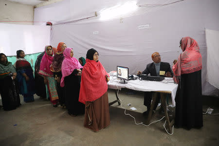 People cast their vote with an Electronic Voting Machine (EVM) for the first time at a voting center during a general election in Dhaka, Bangladesh, December 30, 2018. REUTERS/Mohammad Ponir Hossain