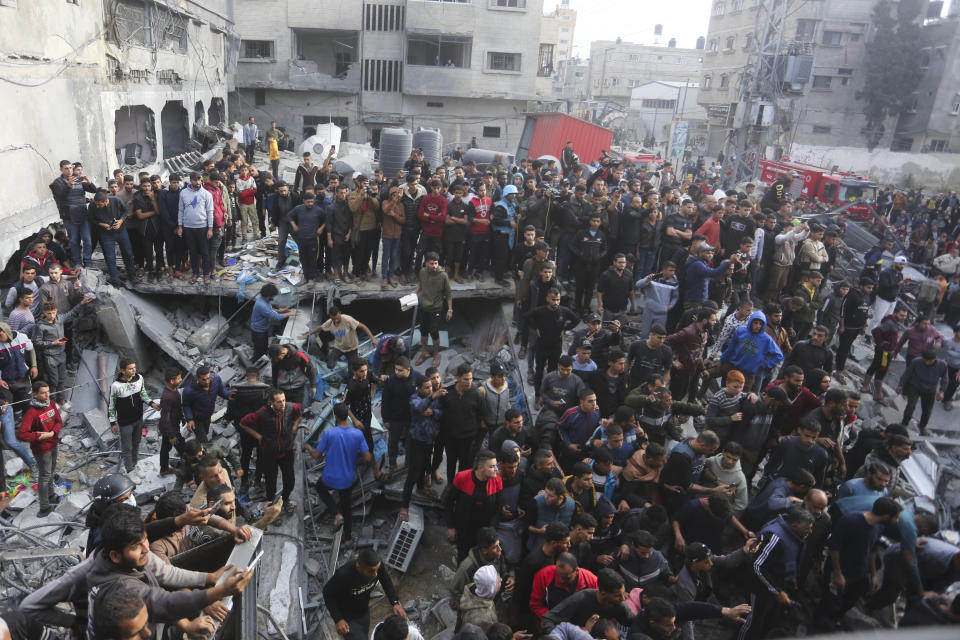 Palestinians look at the destruction after an Israeli strike in Rafah, Gaza Strip, Wednesday, Dec. 20, 2023. (AP Photo/Hatem Ali)