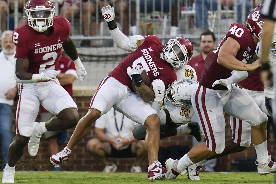 Oklahoma quarterback Micah Bowens (5) is tackled by Kent State linebacker Marvin Pierre (33) in the first half of an NCAA college football game, Saturday, Sept. 10, 2022, in Norman, Okla. (AP Photo/Sue Ogrocki)