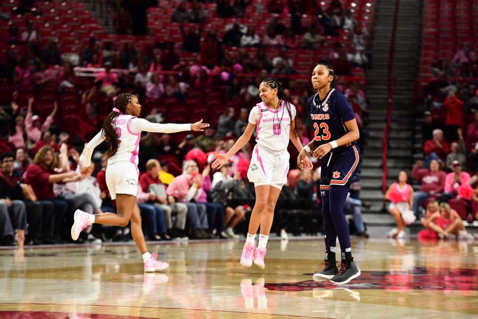 Arkansas women's basketball guard Taliah Scott (0) and Samara Spencer (2) celebrate a basket during the Razorbacks' win over Auburn earlier this year.