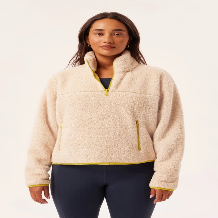 model in cream quarter-zip fleece