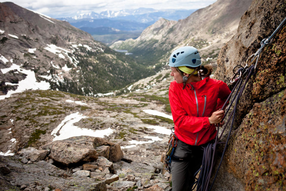 Climber setting an anchor and belaying her partner on a trad route on the Spear Head (North Ridge) in Rocky Mountain National Park