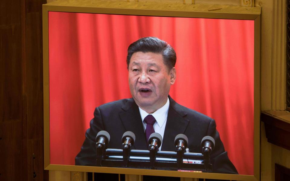 A live image of China's President Xi Jinping is seen on a screen as he delivers a speech during the closing session of the National People's Congress at the Great Hall of the People in Beijing on March 20  - AFP