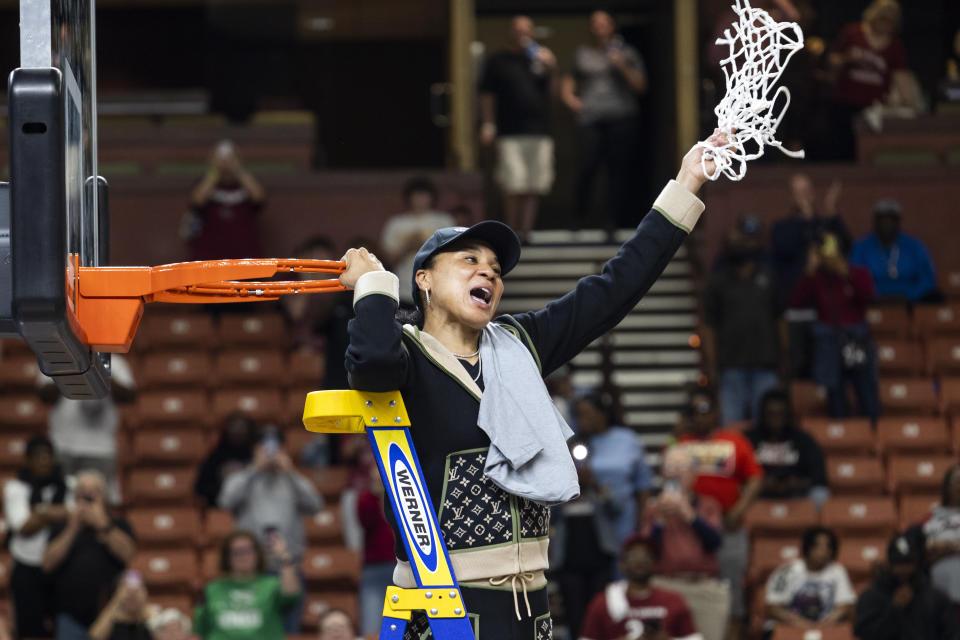 South Carolina head coach Dawn Staley celebrates with the net after defeating Maryland in an Elite 8 college basketball game of the NCAA Tournament in Greenville, S.C., Monday, March 27, 2023. (AP Photo/Mic Smith)