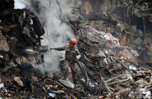 Firefighters and rescuers work at the site where three buildings collapsed in Rio de Janeiro. Rescue efforts have been under way since late Wednesday when the three office buildings -- of 20, 10, and four stories -- collapsed