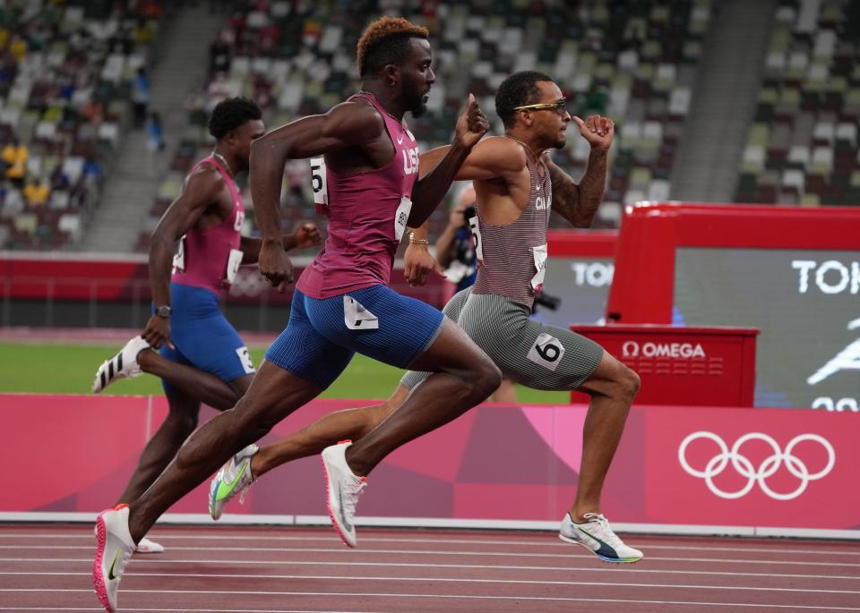 Andre de Grasse of Canada defeats Kenneth Bednarek and Noah Lyles of the USA to win the men's 200m final.