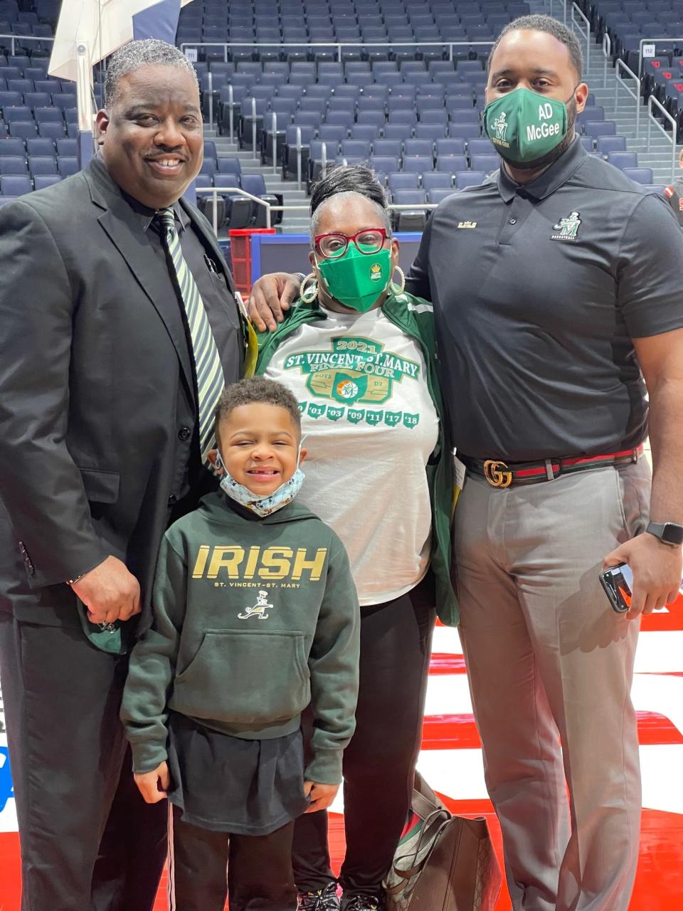 Willie McGee, right, smiles with sister-in-law, Vikkie McGee, nephew, Angelo McGee, and brother, Illya McGee in 2021 after the St. Vincent-St. Mary boys basketball team won the Division II state championship at the University of Dayton Arena.