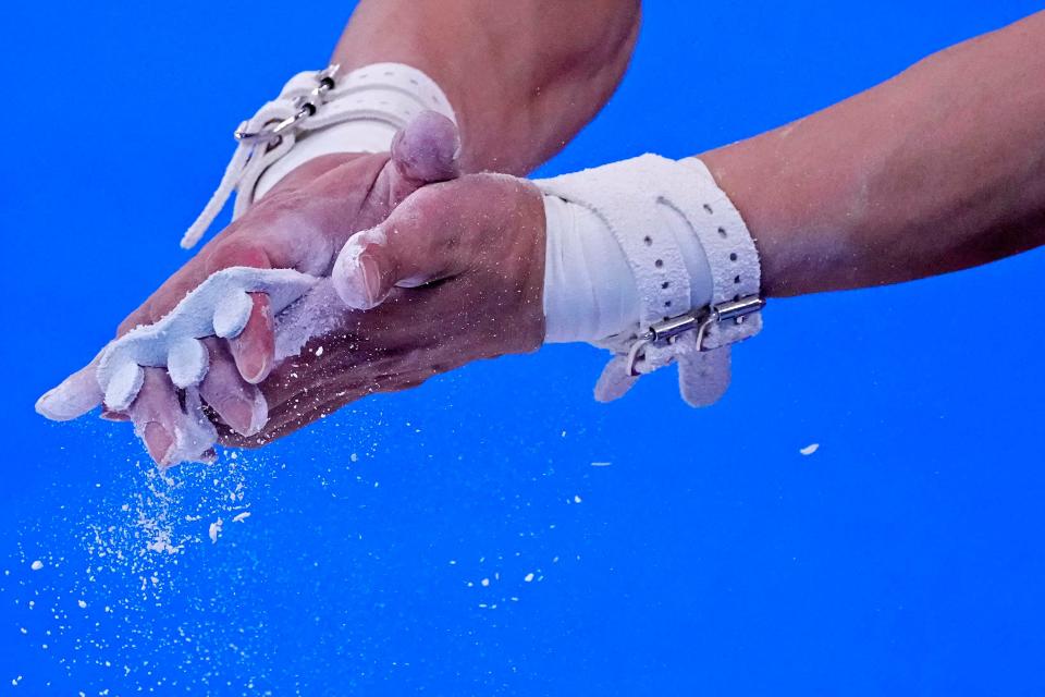 A gymnast chalks his hands in the Mens Gymnastics - Subdivision 2 during the Tokyo 2020 Olympic Summer Games at Ariake Gymnastics Centre on July 24, 2021. 