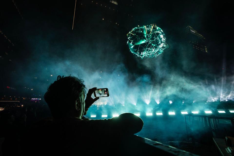 Bystanders watch as Netflix displays a 3D visual experience promoting 3 Body Problem at 4th Street and Congress Avenue during SXSW Friday, March 8, 2024.