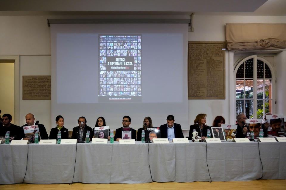 Family members attend a press conference at the Italian Jewish Center in Rome, Wednesday, Nov. 22, 2023, with other representatives of the families of the Israelis abducted by Hamas on Oct. 7 and believed to be held hostages in Gaza, shortly after they met with Pope Francis at The Vatican. The slide on the screen reads in Italian: "Help us bring them home". (AP Photo/Gregorio Borgia)