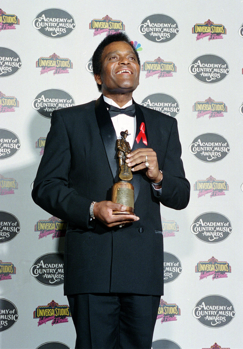 FILE - In this May 3, 1994 file photo, country singer Charley Pride poses with the Pioneer Award he received at the 29th Academy of Country Music Awards show in Universal City, Calif. In 2000, Pride was inducted into the Country Music Hall of Fame. (AP Photo/Lois Bernstein, File)