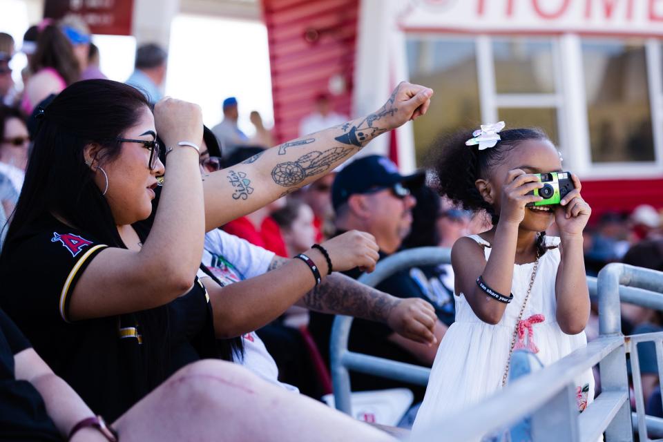 A fan takes a picture with an instant camera during an NCAA softball game between Utah and UCLA at Dumke Family Softball Stadium in Salt Lake City on April 29, 2023. | Ryan Sun, Deseret News