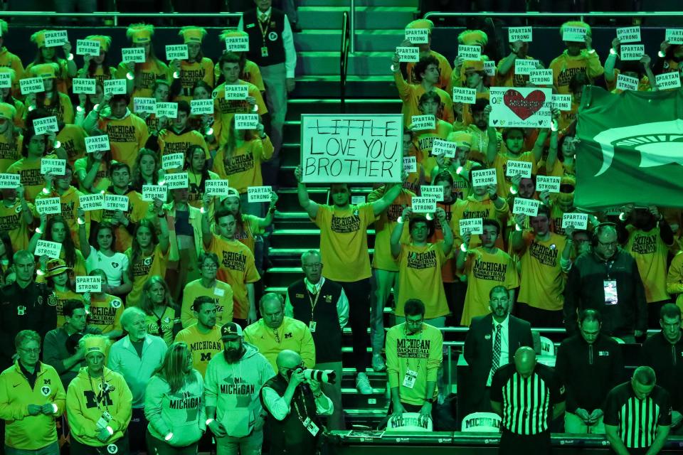 Michigan fans hold "Spartan Strong" signs in the Maize Rage student section to show their support for the Michigan State community before the first half against Michigan State at Crisler Center in Ann Arbor on Saturday, February 18, 2023.