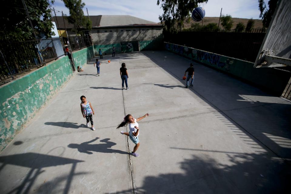 Migrant children play at the Agape World Mission shelter used mostly by Mexican and Central American migrants who are applying for asylum in the U.S., on the border in Tijuana, Mexico, Monday, June 10, 2019. The mechanism that allows the U.S. to send migrants seeking asylum back to Mexico to await resolution of their process has been running in Tijuana since January. (AP Photo/Eduardo Verdugo)