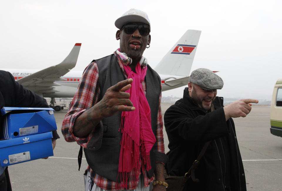 Former NBA basketball star Dennis Rodman, third left, and his entourage arrive at the international airport in Pyongyang, North Korea, Monday, Jan. 6, 2014. Rodman took a team of former NBA players on a trip for an exhibition game on Kim Jong Un's birthday, Wednesday, Jan. 8. (AP Photo/Kim Kwang Hyon)