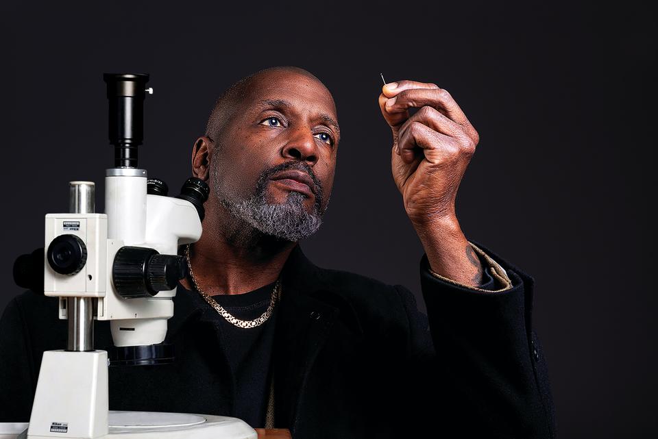 Willard Wigan MBE looking through the eye of a needle