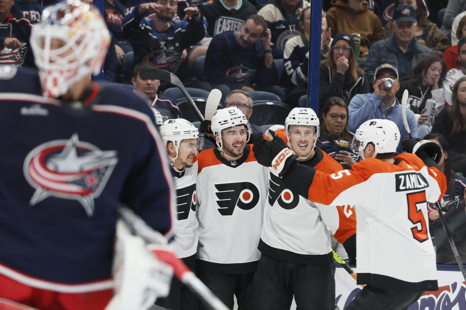 Philadelphia Flyers celebrate a goal against Columbus Blue Jackets' Elvis Merzlikins, foreground, during the first period of an NHL hockey game Thursday, Oct. 12, 2023, in Columbus, Ohio. (AP Photo/Jay LaPrete)