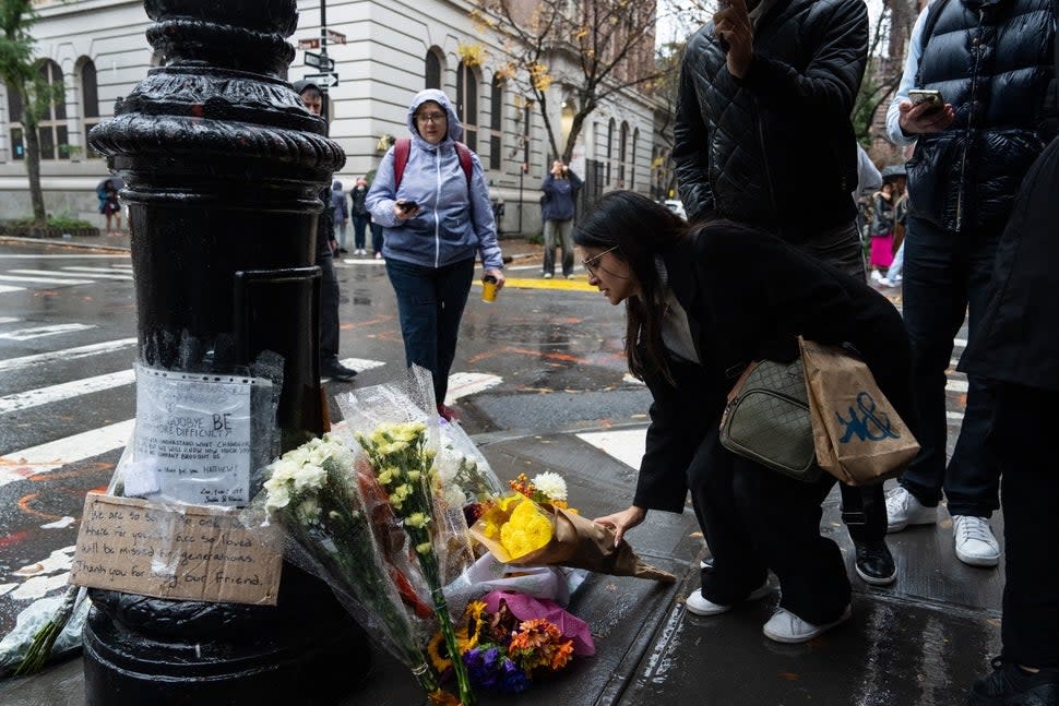 People place flowers in tribute to actor Matthew Perry outside the apartment building which was used as the exterior shot in the TV show 