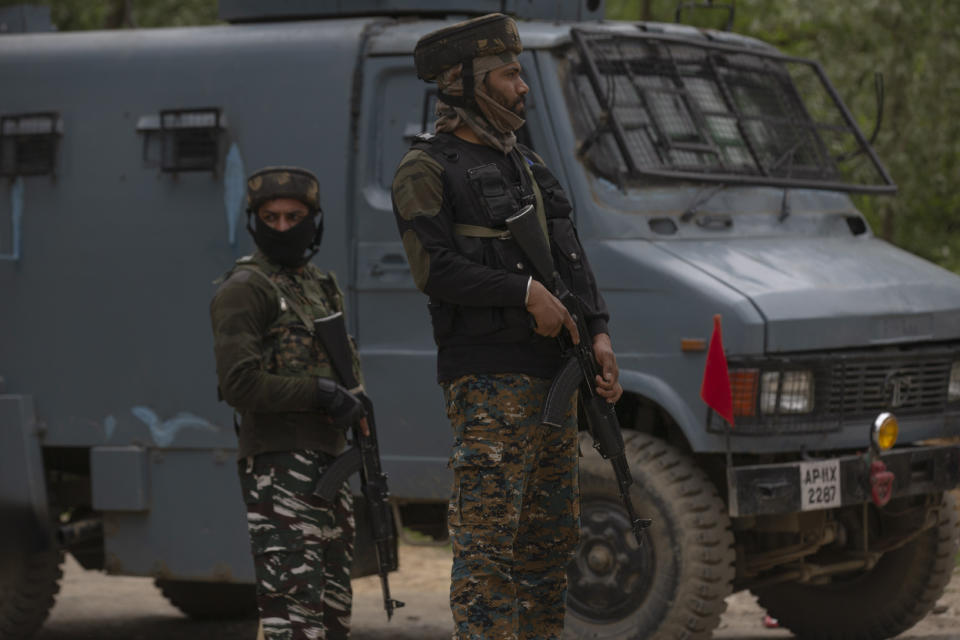 Indian paramilitary soldiers stand guard as police and army soldiers launch an operation in Awantipora area, south of Srinagar, Indian controlled Kashmir, Wednesday, May 6, 2020. Government forces killed a top rebel commander and his aide in Indian-controlled Kashmir on Wednesday and shut down cellphone and mobile internet services during subsequent anti-India protests, officials, and residents said. (AP Photo/ Dar Yasin)