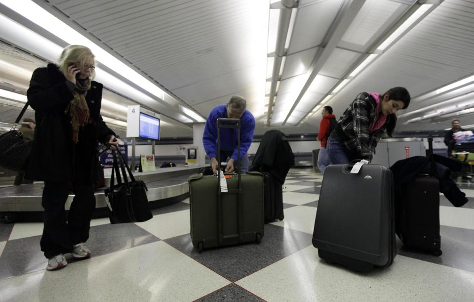 FILE - In this Dec. 22, 2011, file photo, travelers check their luggage at an United Airlines baggage claim area at O'Hare International Airport in Chicago. Airlines are slowly, steadily recovering from their meltdown five years ago, when, under the strain of near-record consumer travel demand, their performance tanked. Industry performance for all four measurements was slightly better in 2011 compared with 2010, according to the report being released Monday, April 2, 2012. (AP Photo/Nam Y. Huh, File)