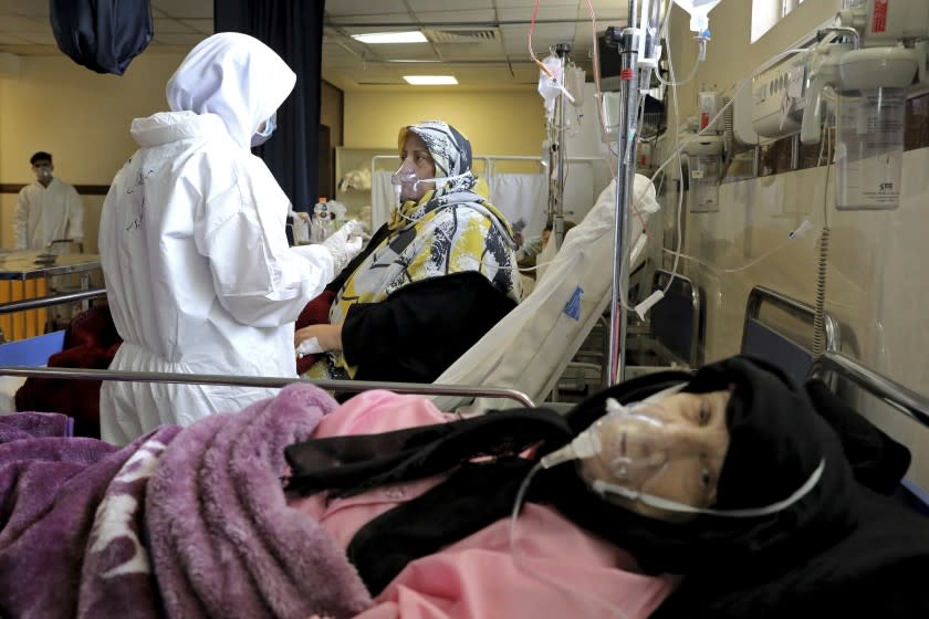 A nurse tends to a patient affected by the COVID-19 virus at the Shohadaye Tajrish Hospital in Tehran, Iran, Saturday, April 17, 2021. After facing criticism for downplaying the virus last year, Iranian authorities have put partial lockdowns and other measures in place to try and slow the coronavirus' spread. (AP Photo/Ebrahim Noroozi)