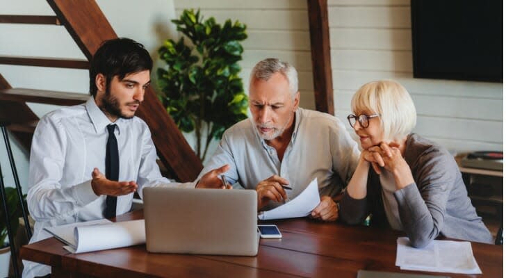 Male financial advisor working with two of his clients