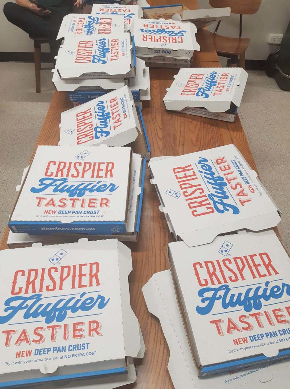 A table of Domino's pizza boxes