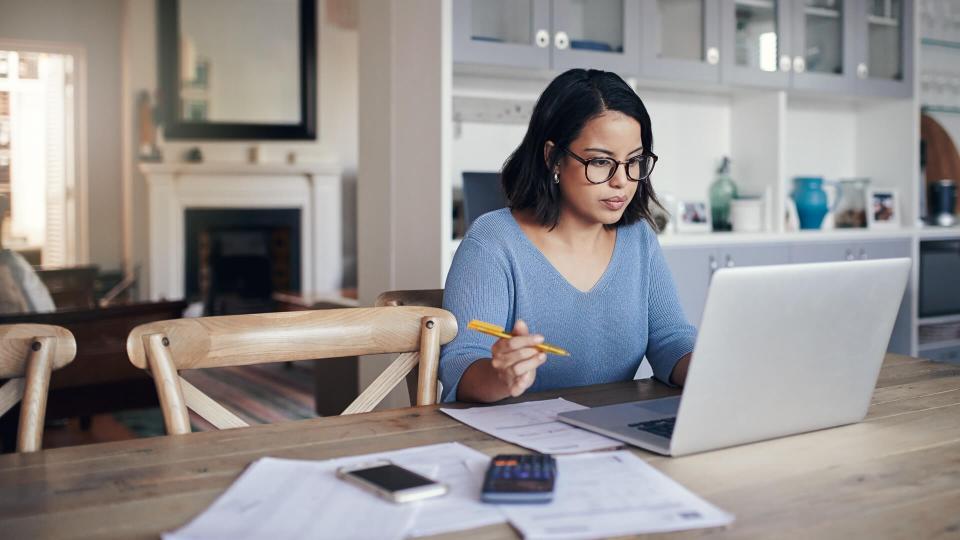 Shot of a young woman using a laptop while working from home.