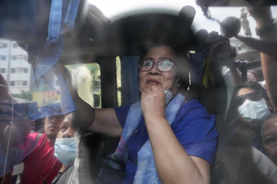 Detained former opposition Senator Leila de Lima, inside a police vehicle, goes out of the Muntinlupa trial court on Friday, May 12, 2023 in Muntinlupa, Philippines. De Lima was acquitted by the Muntinlupa court in one of her drug related charges she says were fabricated by former President Rodrigo Duterte and his officials in an attempt to muzzle her criticism of his deadly crackdown on illegal drugs. (AP Photo/Aaron Favila)