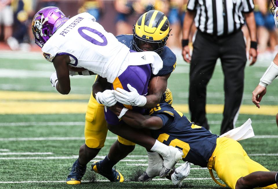 Michigan linebacker Ernest Hausmann (15) tackles East Carolina wide receiver Jhari Patterson during the second half of U-M's 30-3 win on Saturday, Sept. 2, 2023, at Michigan Stadium.