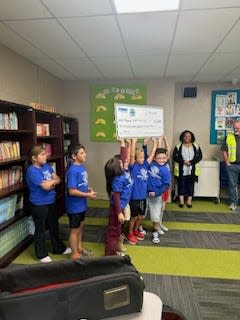 Maverick Boys and Girls Club of Amarillo Shining Stars hold the check representing the $10,750 donation from Atmos Energy, presented to the organization Thursday afternoon at the club's location, 1923 S Lincoln St.