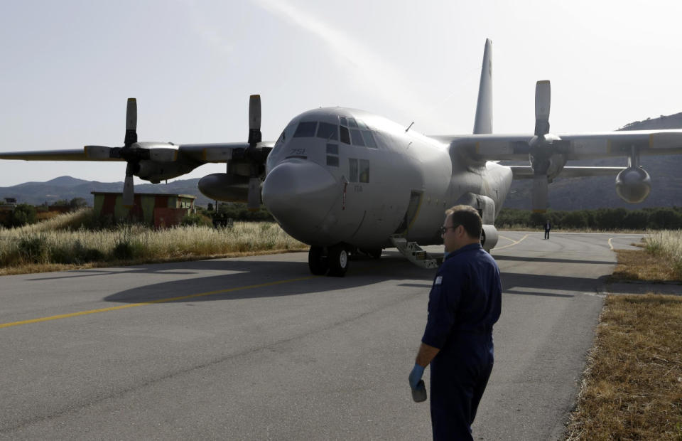 An engineer stands in front of a C-130 HAUP of the Hellenic Air Force, which took part in the search operation for the missing EgyptAir plane, at the military air base of Kastelli on Crete, May 20, 2016. (AP Photo/Thanassis Stavrakis)