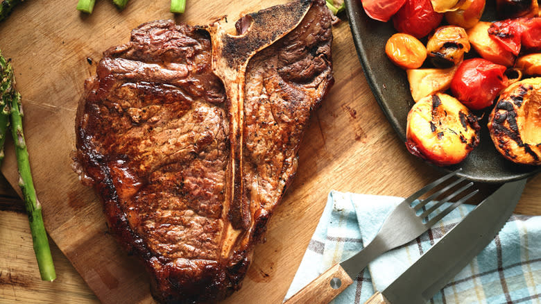 T-bone steak with sides and silverware 