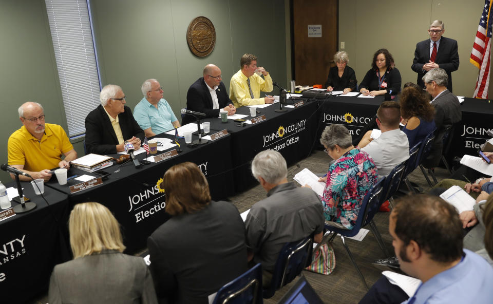 Johnson County chief council Don Jarrett speaks during the Johnson County Board of Canvassers meeting, Monday, Aug. 13, 2018, in Olathe, Kan. County election officials across Kansas on Monday began deciding which provisional ballots from last week's primary election will count toward the final official vote totals, with possibility that they could create a new leader in the hotly contested Republican race for governor. Secretary of State Kris Kobach led Gov. Jeff Colyer by a mere 110 votes out of more than 313,000 cast as of Friday evening. (AP Photo/Charlie Neibergall)