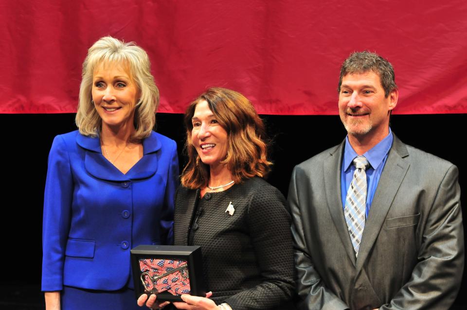 From left, Mayor Shaunna O'Connell, Lt. Gov. Karyn Polito and O'Connell's husband Ted O'Connell pause for a photo during the City of Taunton inauguration ceremony at Taunton High School on Jan. 3, 2022. O'Connell gave Polito a key to the city.