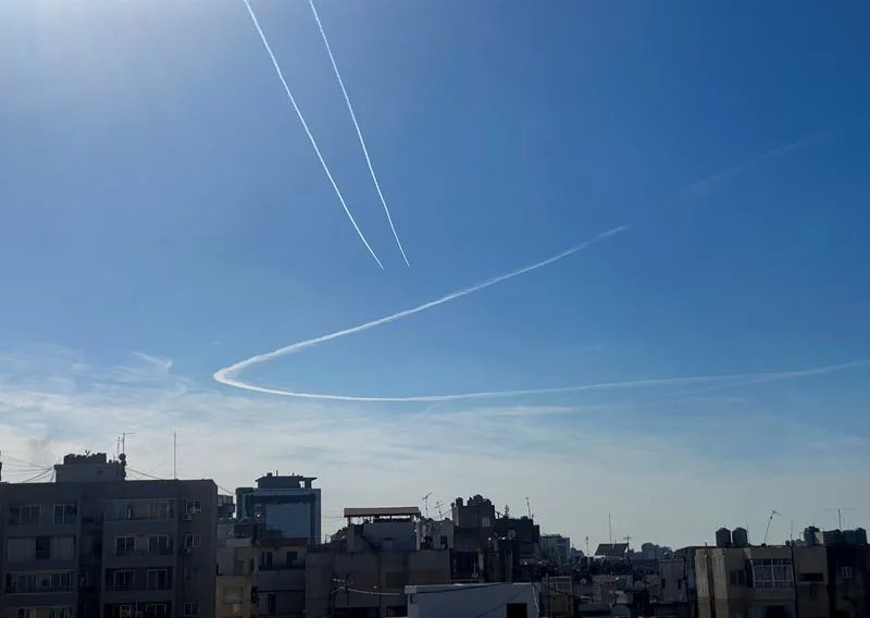 Aircraft leave vapour trails in the sky above Beirut