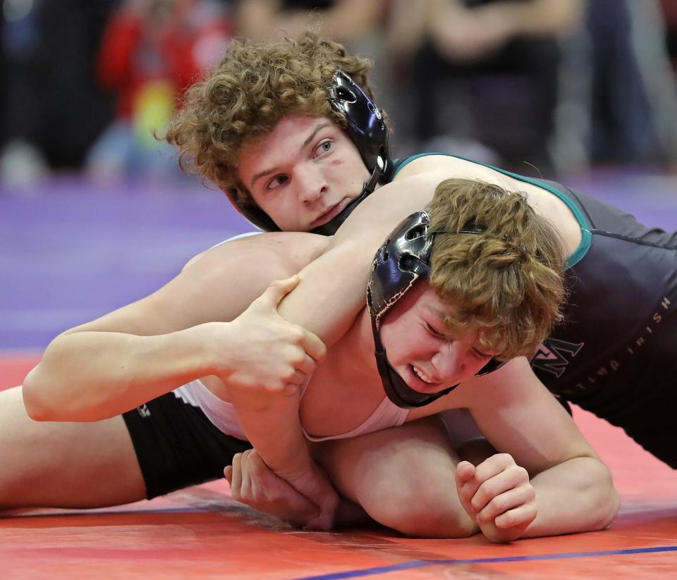 St. Vincent-St. Mary's Bryce Skinner, right, was one of seven Fighting Irish wrestlers to pick up two wins to help the team qualify for the Division II State Duals for the first time since 2018.