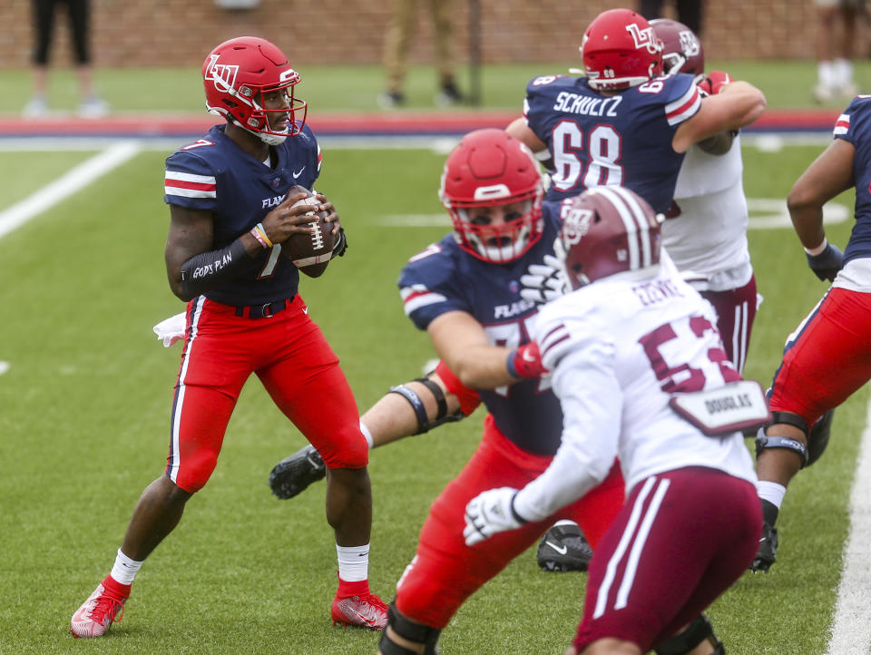 Liberty quarterback Malik Willis (7) looks to make a pass during the first half of a NCAA college football game against Massachusetts on Friday, Nov. 27, 2020, at Williams Stadium in Lynchburg, Va. (AP Photo/Shaban Athuman)