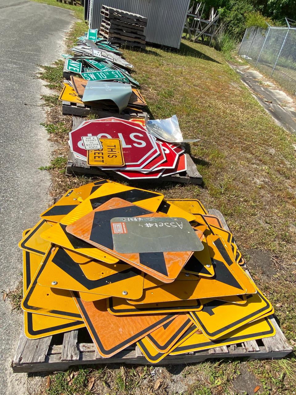 A stack of Gainesville street signs, among other items, can be purchased be anyone through a surplus bidding site for local government entities.